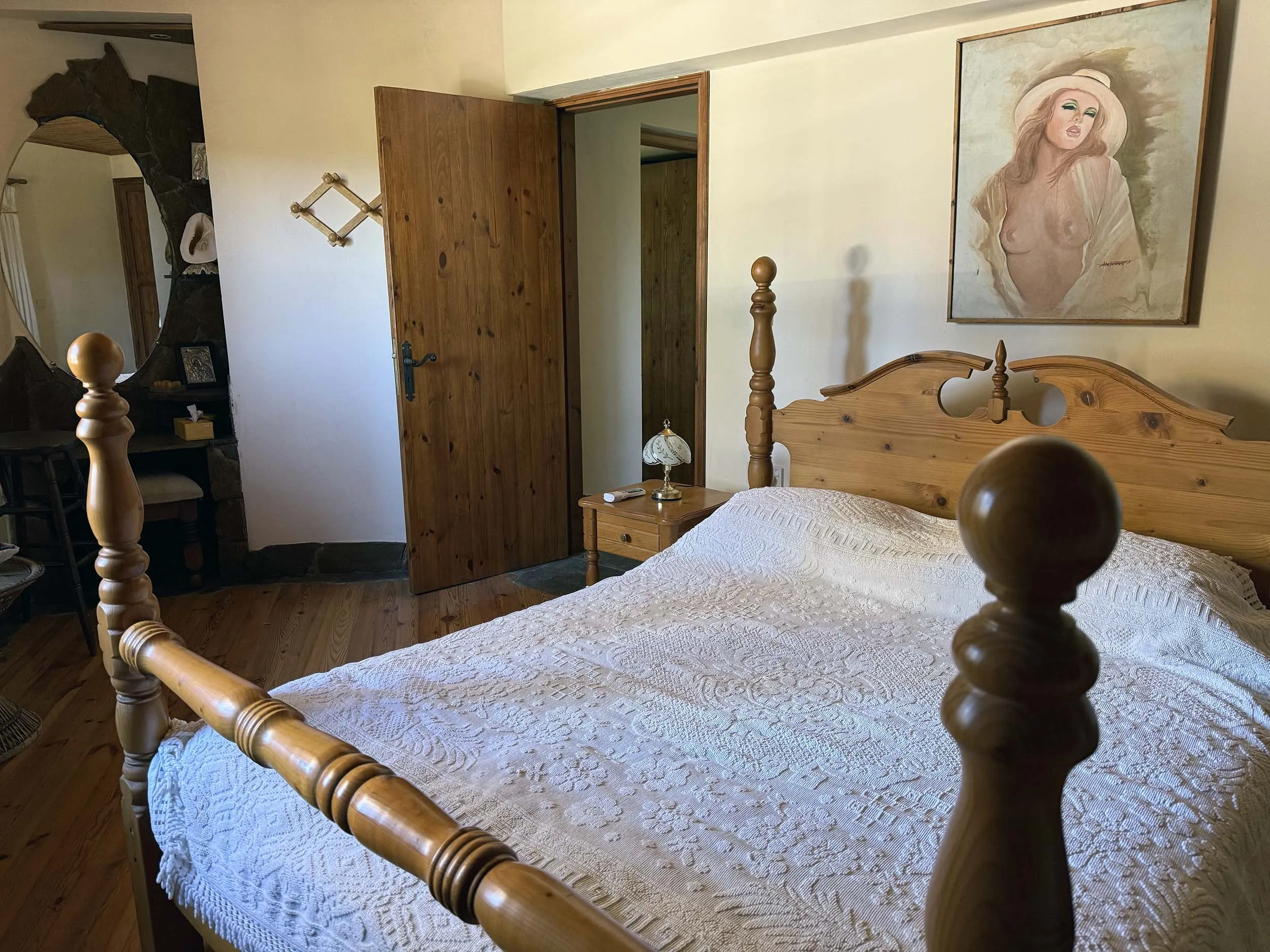 Charming bedroom with pine four-poster bed, hardwood floors and traditional furnishings
